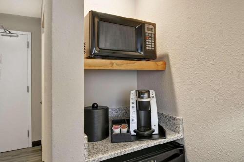 a microwave sitting on a shelf with a coffee maker at Hilton Garden Inn Oshkosh in Oshkosh