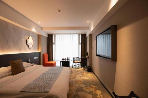 a hotel room with a bed and a television at New Friendship Hotel in Luoyang