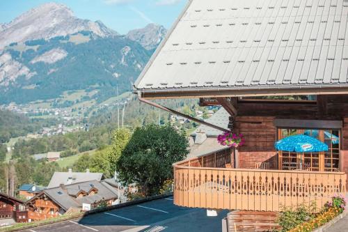 a house with a balcony with a view of a mountain at Appartement spacieux à Châtel 120 m² avec terrasse privée in Châtel