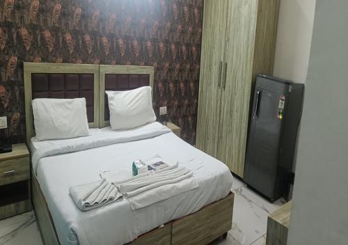a bedroom with a bed with a book and a tv at Akshay dream stay in Gurgaon
