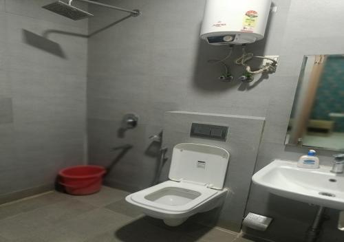 a bathroom with a toilet and a sink at Akshay dream stay in Gurgaon