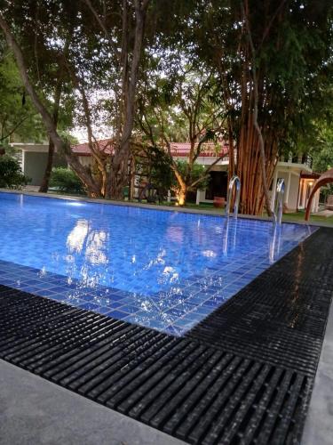 a pool with water fountains in the middle at VinSri Villa in Kurunegala