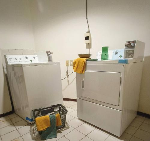 a kitchen with a refrigerator and a washing machine at Deja Vu Hotel in Taipei
