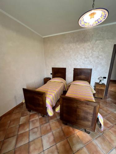 a bedroom with two beds and a chandelier at La Fonte B&B in Baranello