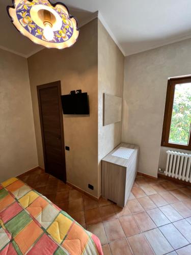 a bedroom with a bed and a window and a chandelier at La Fonte B&B in Baranello