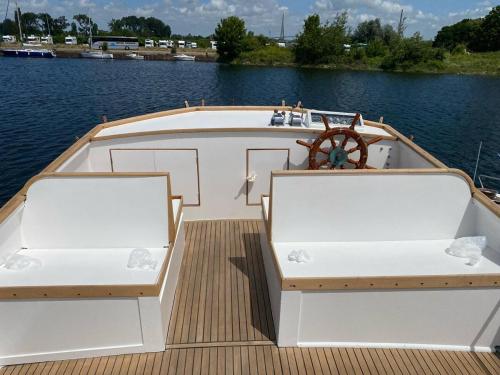 deux chaises sur un bateau sur un plan d'eau dans l'établissement Nuit insolite a bord d un bateau, à Caen