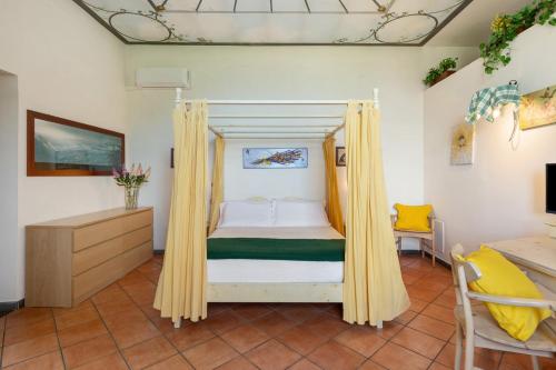 a bedroom with a bed with yellow curtains at Agriturismo Barone Antonio Negri in Fisciano