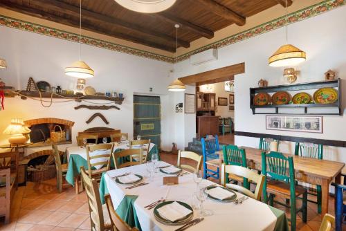 a restaurant with tables and chairs and a fireplace at Agriturismo Barone Antonio Negri in Fisciano