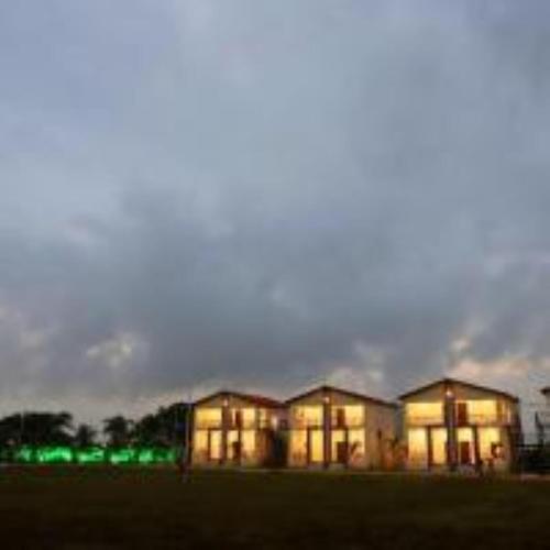 a large building with green lights on it at night at VITS Select Diamond Resort Sasan Gir in Talala