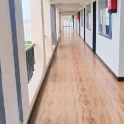 an empty hallway of an office with a wooden floor at VITS Select Diamond Resort Sasan Gir in Talala