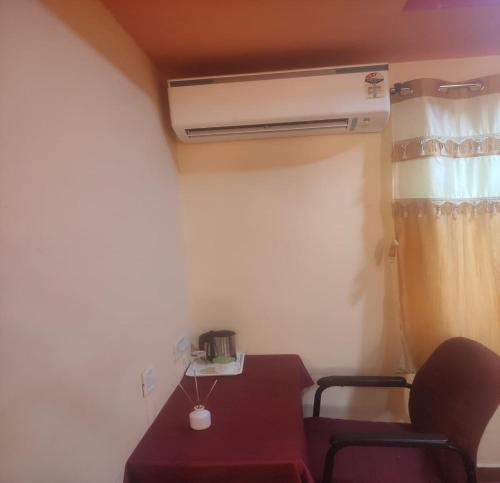 a room with a table and a air conditioner at Hotel ST Thomas International Centre in Chennai
