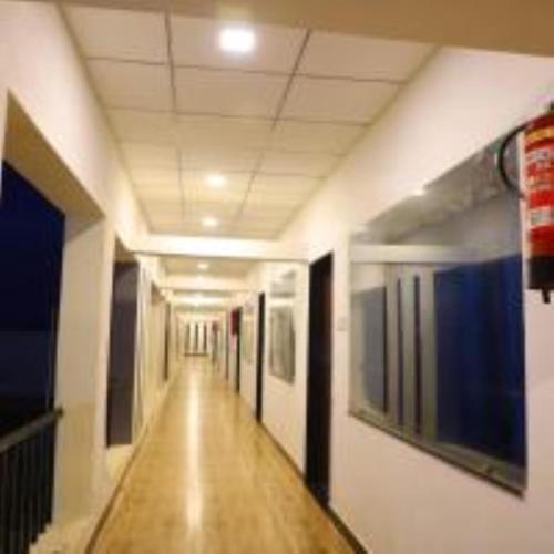 an empty hallway in a building with a long corridor at VITS Select Diamond Resort Sasan Gir in Talala