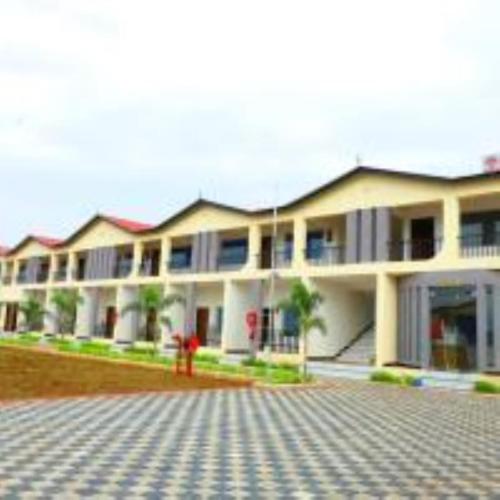 a large white building with a lot of windows at VITS Select Diamond Resort Sasan Gir in Talala