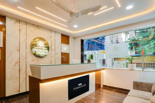 a restaurant lobby with a sign on the wall at Super Townhouse Sri Nirvana Grand in Hyderabad