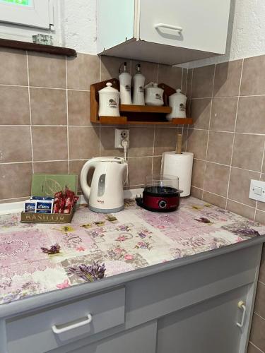 a kitchen counter top with appliances on it at Sailor's Rustic House in Virpazar