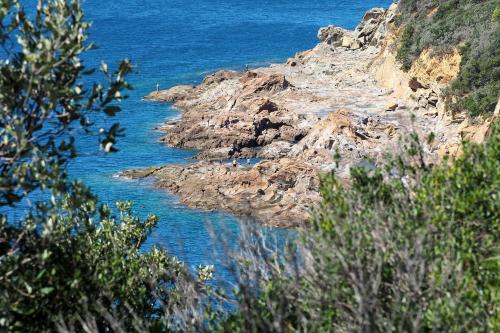 a view of a rocky shore with the ocean at Urlaub, wo die Toskana noch authentisch ist - Rustico aus 16Jh mit Infinity Pool in Pomarance