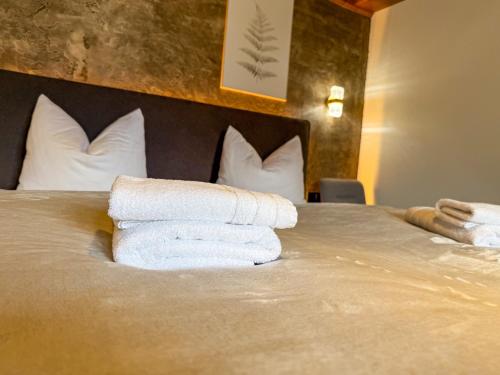 a pile of towels sitting on top of a bed at Luna Studios Zillertal in Hippach