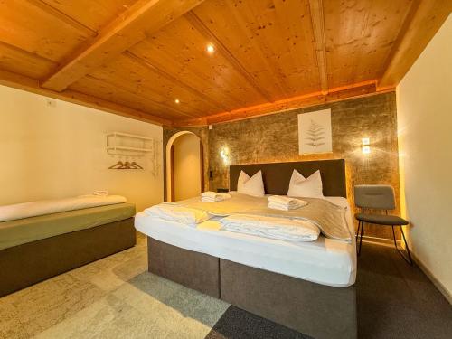 a bedroom with a bed and a chair in it at Luna Studios Zillertal in Hippach