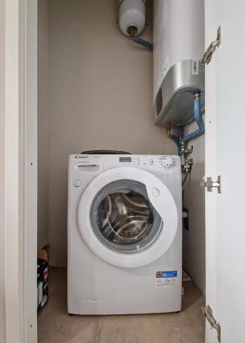 a washer and dryer sitting in a laundry room at Downtown Pavia, a stone's throw from the station and the center in Pavia