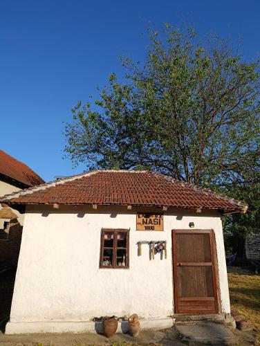 a small white building with a sign on it at Vila Jagoda in Bojnik