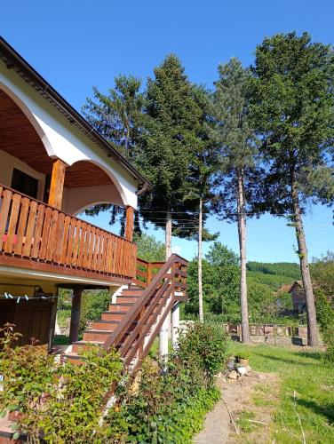 a deck on the side of a house with trees at Vila Jagoda in Bojnik