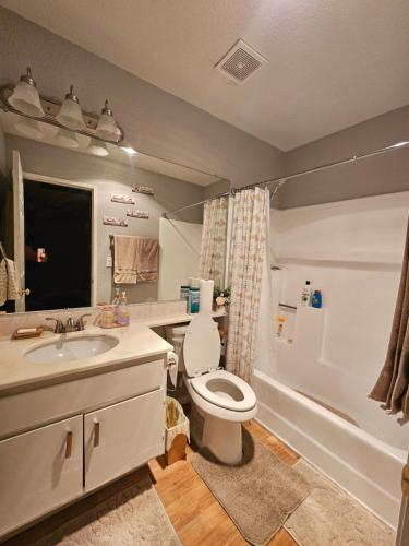 a bathroom with a toilet and a sink at Minsa - Peaceful Home near LAX DTLA & Free Parking in Lawndale