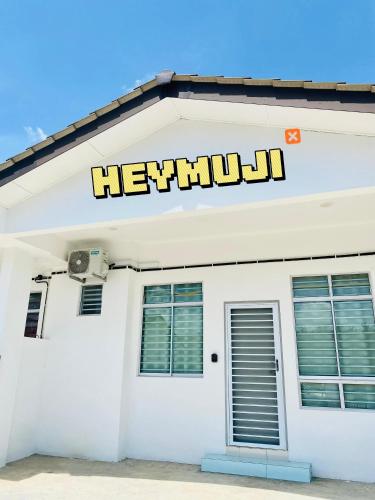a white building with the word herkunil on it at HeyMuji Projector-Netflix-Darts-Near Lotus in Kluang