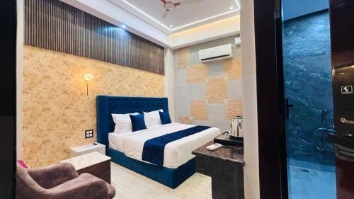 a hotel room with a bed and a chair at Shri Shyam Luxury Hotel in Har Ki Paudi in Haridwār