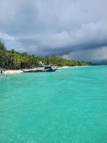 a view of a beach with boats in the water at Tara staycation unit in Boracay