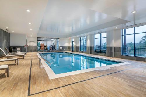 a large swimming pool in a building with windows at Cambria Hotel Lake Placid - Lakeside Resort in Lake Placid