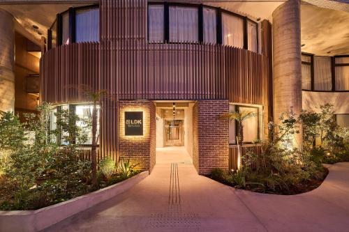 a lobby of a building with a brick wall at GRAND HOSTEL LDK Tokyo Nishikasai -GRAND OPENING In May 2025- in Tokyo