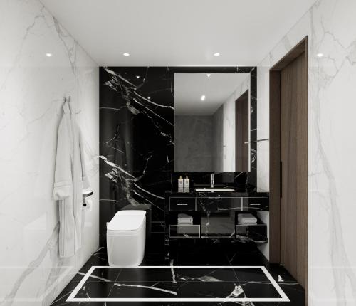 a black and white bathroom with a toilet and a sink at The Siena PRIMO in Seogwipo