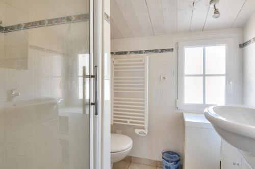 a white bathroom with a sink and a toilet at 500 m de la plage - Maison pour 6 - Terrasse in LʼÉpine