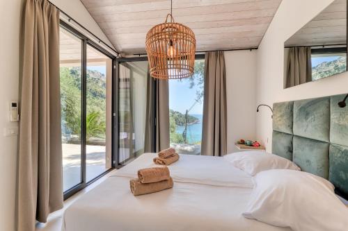 a bedroom with two beds and a large window at Villaggio Balzi Rossi in Ventimiglia