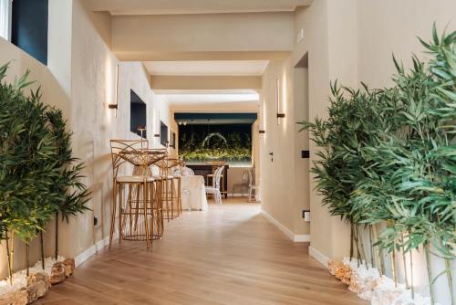 a hallway with potted plants in a house at Kira suite and rooms in Pozzuoli