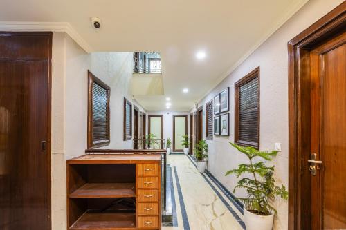 a hallway with wooden cabinets and plants in a house at Tribe - Bespoke Hotel by FlxHo Arjun Marg DLF Phase 1 Golf Course Road in Gurgaon