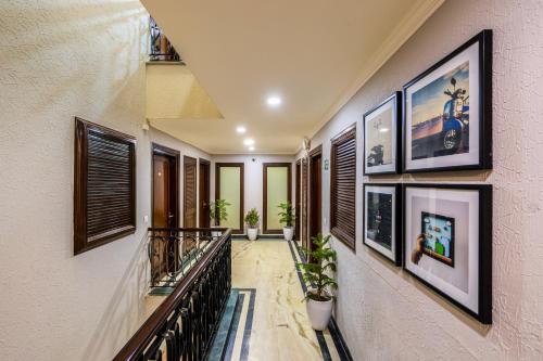 a hallway with pictures on the wall and a staircase at Tribe - Bespoke Hotel by FlxHo Arjun Marg DLF Phase 1 Golf Course Road in Gurgaon