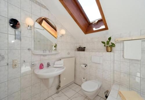 a white bathroom with a sink and a toilet at Studio Voglesang in Spiegelau