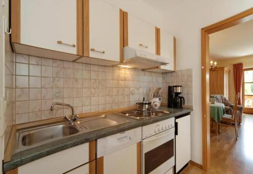 a kitchen with a sink and a stove at Studio Voglesang in Spiegelau