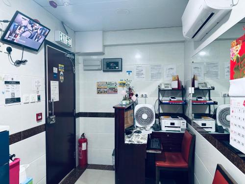 a kitchen with a counter with a microwave at KATHMANDU GUEST HOUSE in Hong Kong