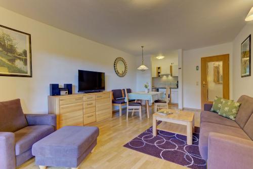 a living room with a couch and a table at Siebensteinkopf in Spiegelau