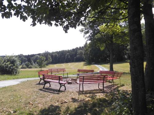 a group of benches sitting in a park at Ferienwohnung Für 4 Personen Ca 37 M Sup2 In Sayda, Mittelgebirge Deutschland Erzgebirge in Sayda