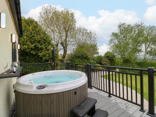 a hot tub on the deck of a house at Highview Stables in Chesterfield