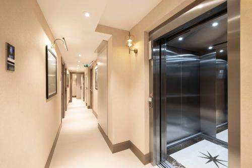 a hallway with a walk in shower and a glass door at Emilion Hotel in Istanbul
