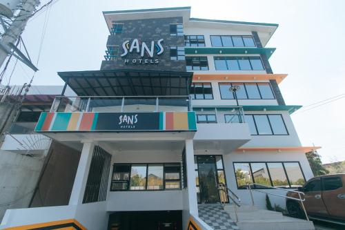 a building with a sign that reads sams properties at Sans Hotel near Enchanted Kingdom Santa Rosa Laguna in Santa Rosa