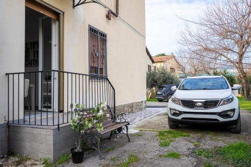 a white suv parked outside of a house at Airport Suite a 15 min centro storico con parcheggio gratuito in Florence