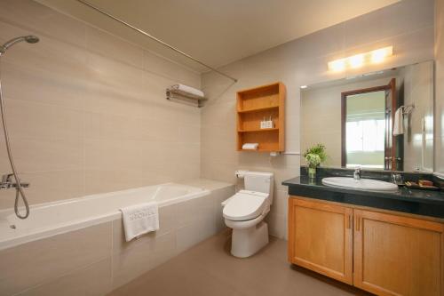 a bathroom with a tub and a toilet and a sink at HTOWER - 197 Văn Cao, Gia Viên, Hải Phòng in Hai Phong