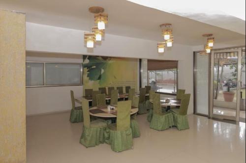a dining room with a table and chairs at VITS Select Bharuch in Bharūch