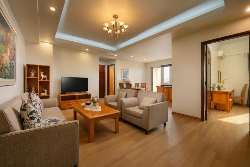 a living room with a couch and chairs and a tv at HTOWER - 197 Văn Cao, Gia Viên, Hải Phòng in Hai Phong