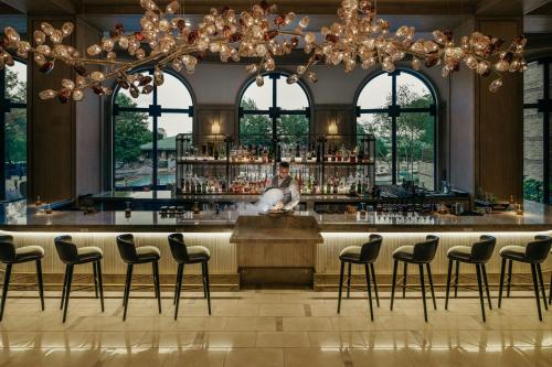 a bar in a building with a chandelier at The Ritz-Carlton Dallas, Las Colinas in Irving